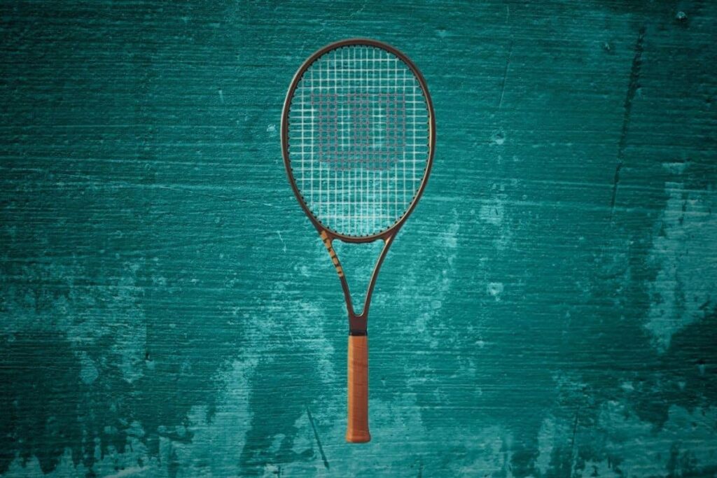 Wilson Pro Staff 97 v14 with an abstract background.